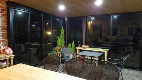 a patio with a table and chairs and a dining room at Jeonju Morning Garden Guest House in Jeonju