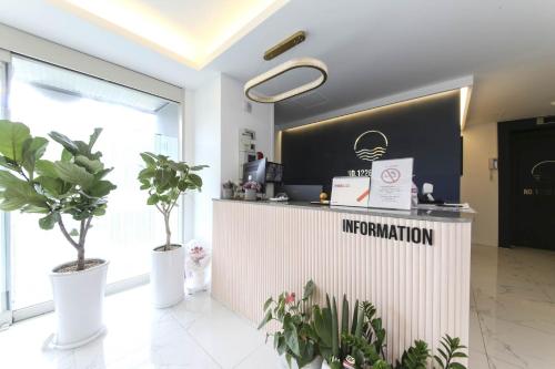 an information counter in a room with potted plants at ND 1226 Hotel in Busan