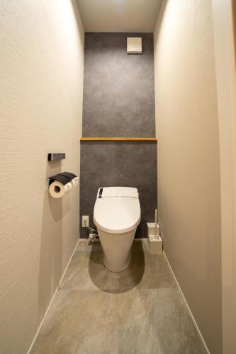 a bathroom with a white toilet in a room at 綯 -NAU- in Yakushima