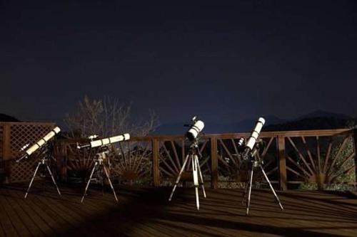 a group of telescopes sitting on a deck at Trapezium Pension Gapyeong in Gapyeong