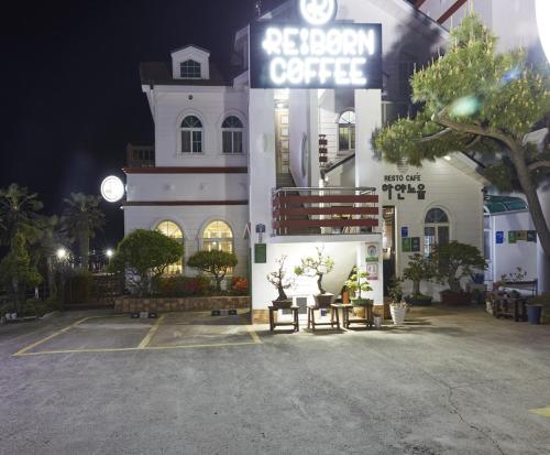 a white building with a sign that reads regional coffee at Goheung hayan noeul hotel in Goheung