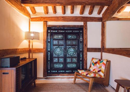a room with a window with a couch and a television at Goheung Namsoonjae Hanok Stay in Goheung