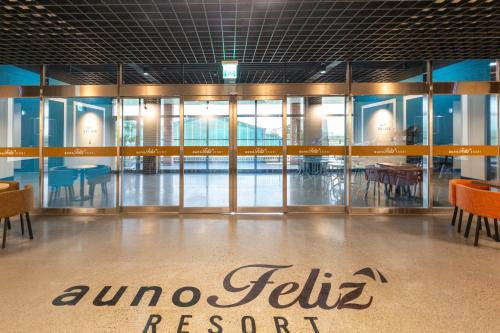 a lobby of a restaurant with glass doors and tables at Yeongcheon Auno feliz in Yeongcheon