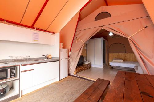 a tent in a kitchen with a wooden floor at Yeongcheon Auno feliz in Yeongcheon