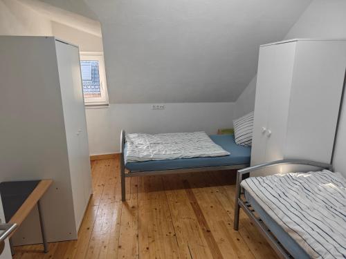 a small room with a bed and two beds in it at Work and Stay Dürwiß IaM Neu Modernisiert in Eschweiler