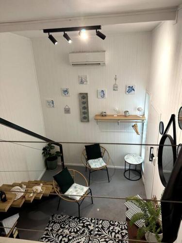 a room with two chairs and a table and a shelf at NEW! Sea Joley Tiny Home in Nelly Bay