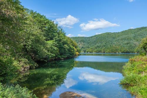 a view of a river with trees on the side at Camel Pension in Pocheon in Pocheon