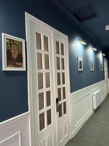 a white door in a room with blue walls at villa gardens in K'obulet'i