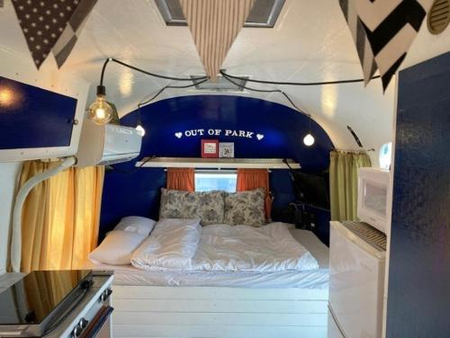 a bedroom with a bed in a rv at Out of Park in Hakik-tong