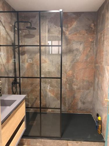 a shower with a glass door in a bathroom at Azul apartment with sea view in Morro del Jable