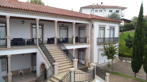 a large building with a balcony and a walkway at Casa do Fontão in Amarante
