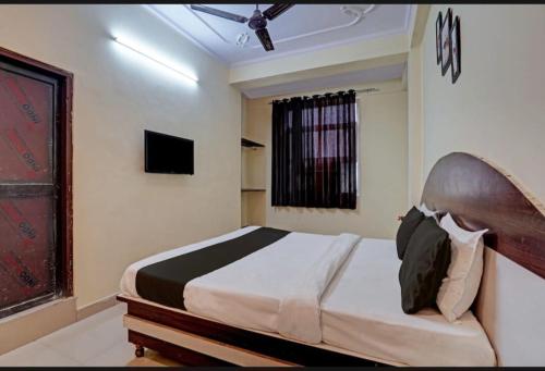 a bedroom with a bed and a television in it at AK VILAS - BEST BUDGETED HOTEL IN JAIPUR in Jaipur