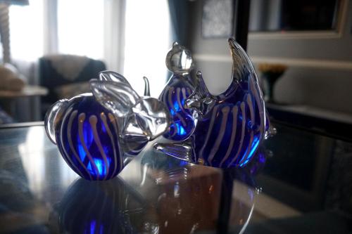 two blue glass vases sitting on a glass table at McKinley Hills BGC Taguig City Condo in Manila