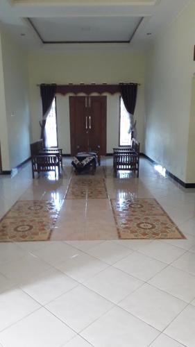 an empty room with chairs and a table in it at Homestay hidayah in Borobudur