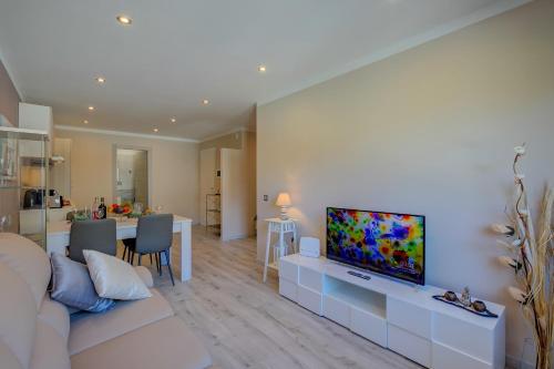 a living room with a couch and a flat screen tv at 4 Seasons Apartment - Happy Rentals in Taverne