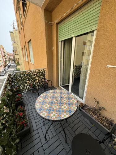 a patio with a table and chairs on a balcony at Fiorini - Rooms in Rome