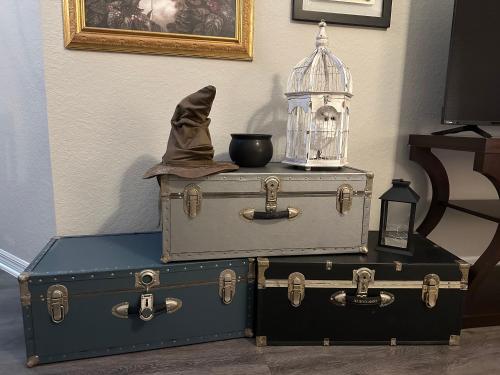 three trunks with a bird cage on top of them at Harry Potter Themed Luxury Apartment 3bd 2bth - Universal Studios in Orlando