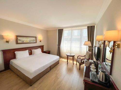 a hotel room with a bed and a television at Bilek Istanbul Hotel in Istanbul