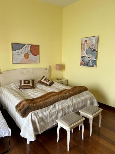 a bedroom with a large bed and two pictures on the wall at Luxery Villa Sea Side in Port Dickson