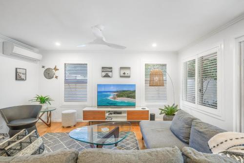 a living room with a couch and a table at Seadrift 31 on Browning Street in Byron Bay