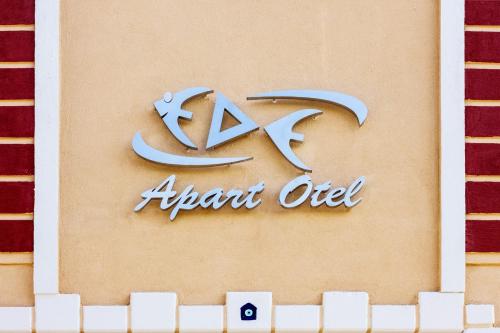 a sign for an arab oil company on a wall at Ede Apart Otel in Geyikli