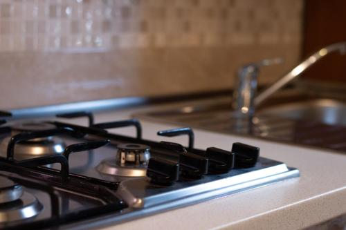 a close up of a stove top with a sink at Casa Vacanze da Vicenta in Marina di Camerota
