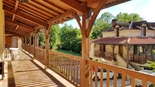 a wooden deck with a house with a gazebo at Villa confortable à Milhars avec piscine privée in Milhars