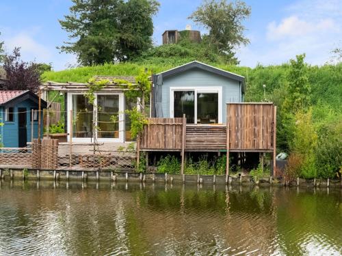 a house on the shore of a body of water at Idyllic Holiday Home in Ooltgensplaat near centre in Ooltgensplaat