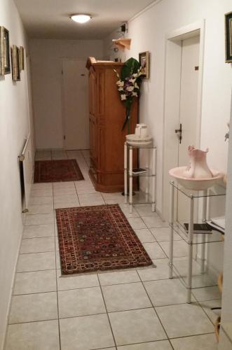 a hallway with a bathroom with two rugs on the floor at Hotel Restaurant Anna in Ramstein-Miesenbach