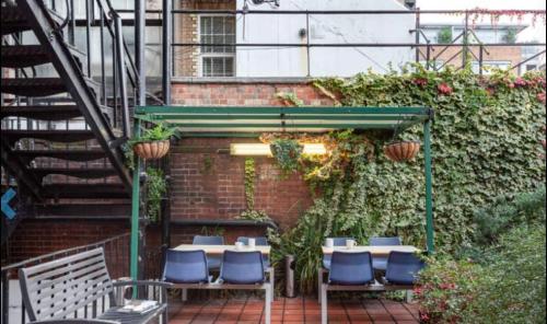 a patio with tables and chairs and a staircase at Private room in rental unit in London