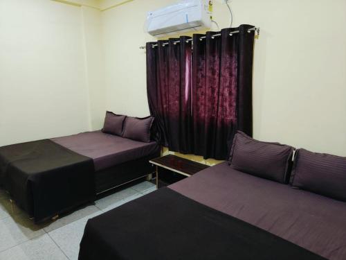 A bed or beds in a room at The Dwarkesh Hotel