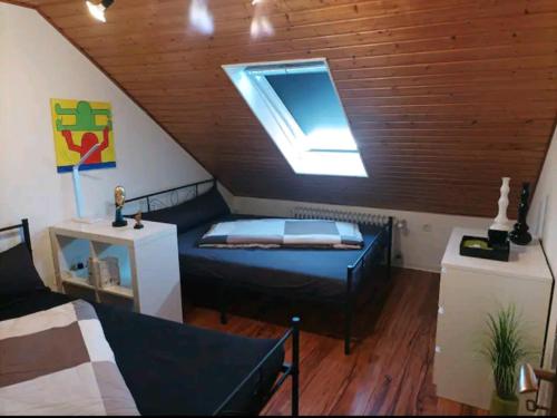 ein Schlafzimmer mit einem Bett und einem Fenster im Dachgeschoss in der Unterkunft Ferien in der Eifel in Berg