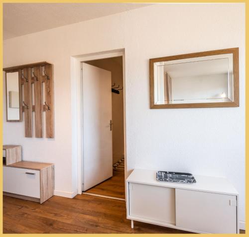 an empty room with a mirror on the wall at Chez Berangere - T1 - St Julien in Saint-Julien-en-Genevois