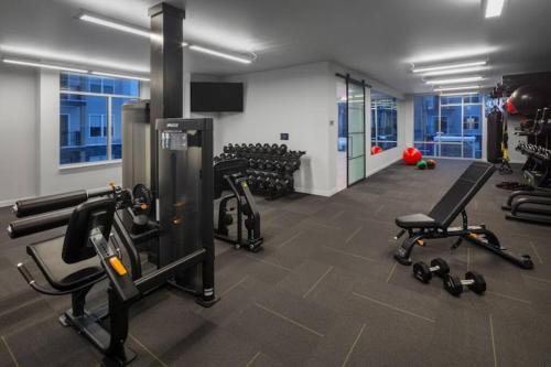 a gym with several treadmills and machines in a room at Retro Retreat in Wauwatosa in Wauwatosa