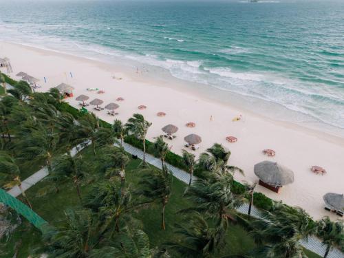 an aerial view of a beach with umbrellas and people at Wyndham Grand Phu Quoc in Phu Quoc