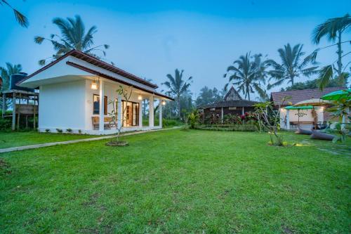 a house with a lawn in front of it at Ritual Ubud in Gianyar