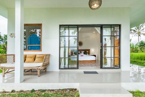 a living room with a couch and a bed at Ritual Ubud in Gianyar