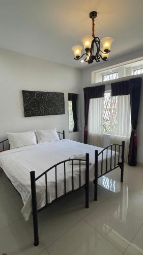 a bedroom with a large bed with a chandelier at Rocky Cafe & Mini Apartment in Siem Reap