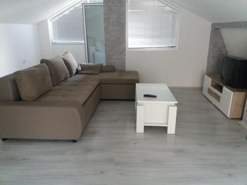 a living room with a couch and a table at Comfortable Slavej Apartment 1 in Sveti Nikole