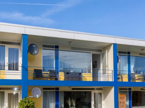 an exterior view of a building with blue and yellow at Attractive apartment near Vlissingen beach in Vlissingen