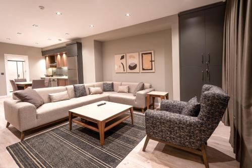 a living room with a couch and two chairs at Verula City Suites in Trabzon