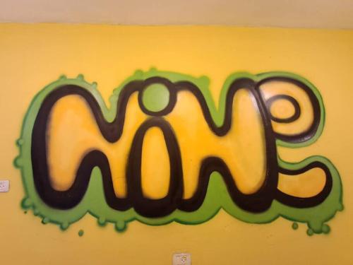 a painting of the word m on a wall at Fellini Nine ground (talpiot) in Haifa