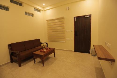 a living room with a couch and a coffee table at PALM PARADISE Beach Resort in Puducherry