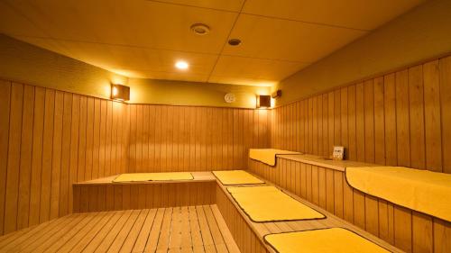 a sauna with two beds in a wooden room at Miyazaki Daiichi Hotel in Miyazaki