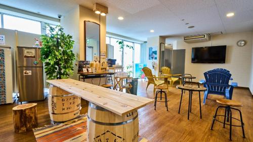 a cafe with tables and chairs and a wooden table at Miyazaki Daiichi Hotel in Miyazaki