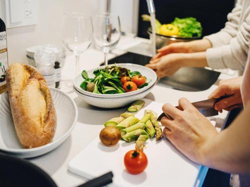 a group of people sitting at a table with food at MIMARU Tokyo Ueno Inaricho in Tokyo