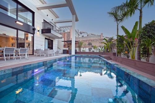 a swimming pool in the backyard of a house at Villa Six Eilat in Eilat