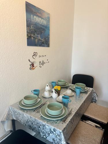 a table with plates and cups on top of it at Käthe-Kollwitz Straße 54, F1 in Altenburg