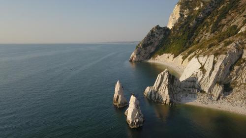 an aerial view of two large rocks in the water at Casina al mare in Porto Recanati