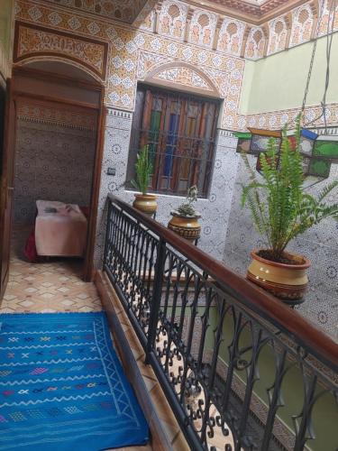 a staircase in a house with a blue carpet at Dar Amane - Charmante maison marocaine in Marrakech